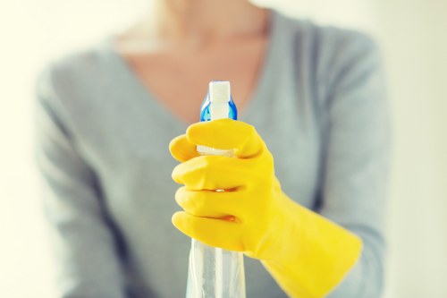 Professional cleaner maintaining a tidy office in West Hampstead